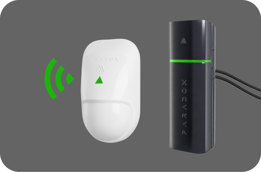 Two Paradox zone source devices — a wireless RF motion detector transmitting a signal, and a wired module — representing the different source types a zone can come from